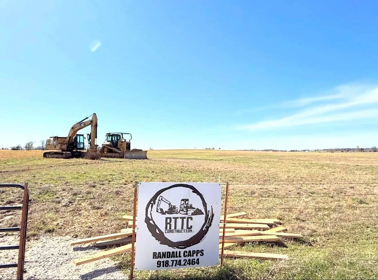 RTTC Construction equipment on a job site with company sign